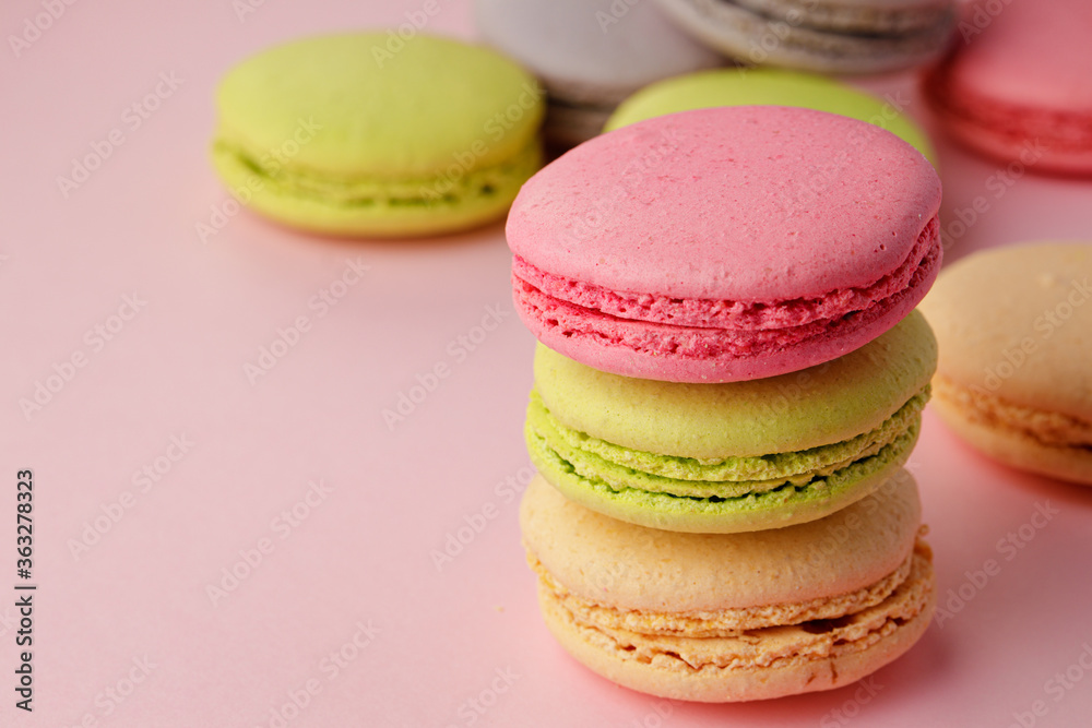 Pile of colorful macaroon cookies on pink background Pile of colorful macaroon cookies on pink background