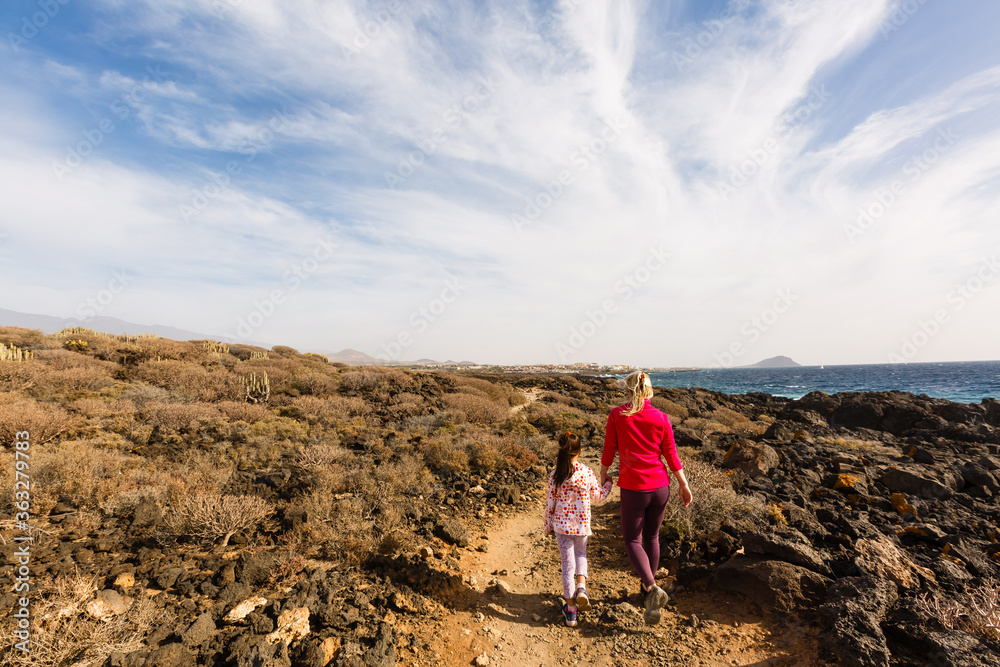 mother with little daughter travel in mountains tenerife