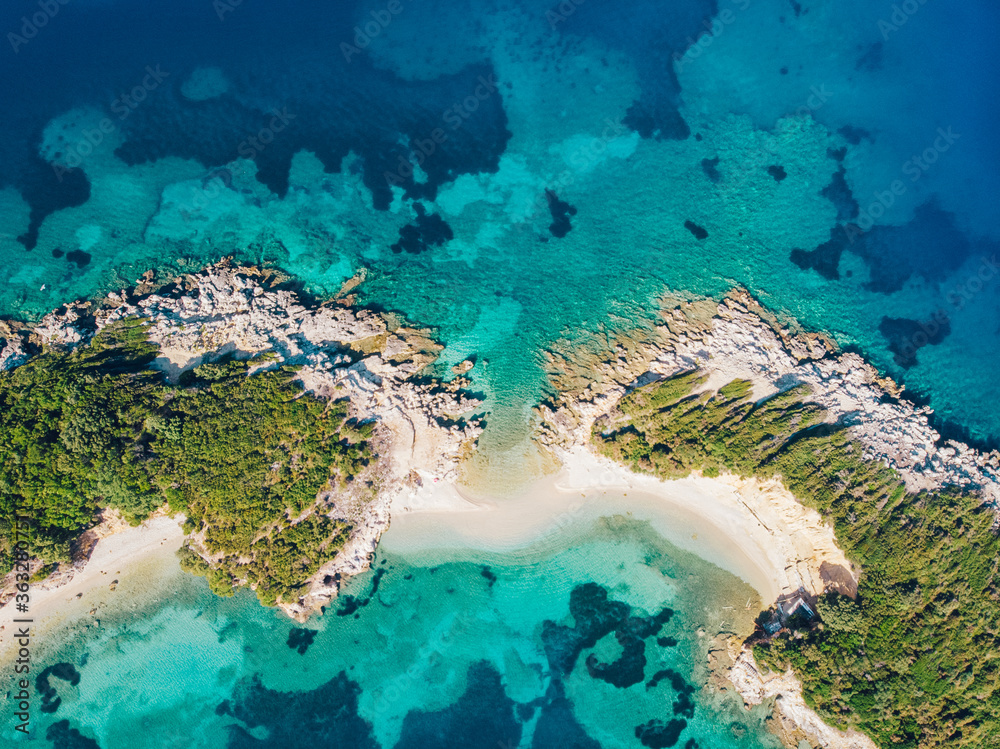 Aerial view of a beautiful deserted island in the turquoise sea. Drone shot.