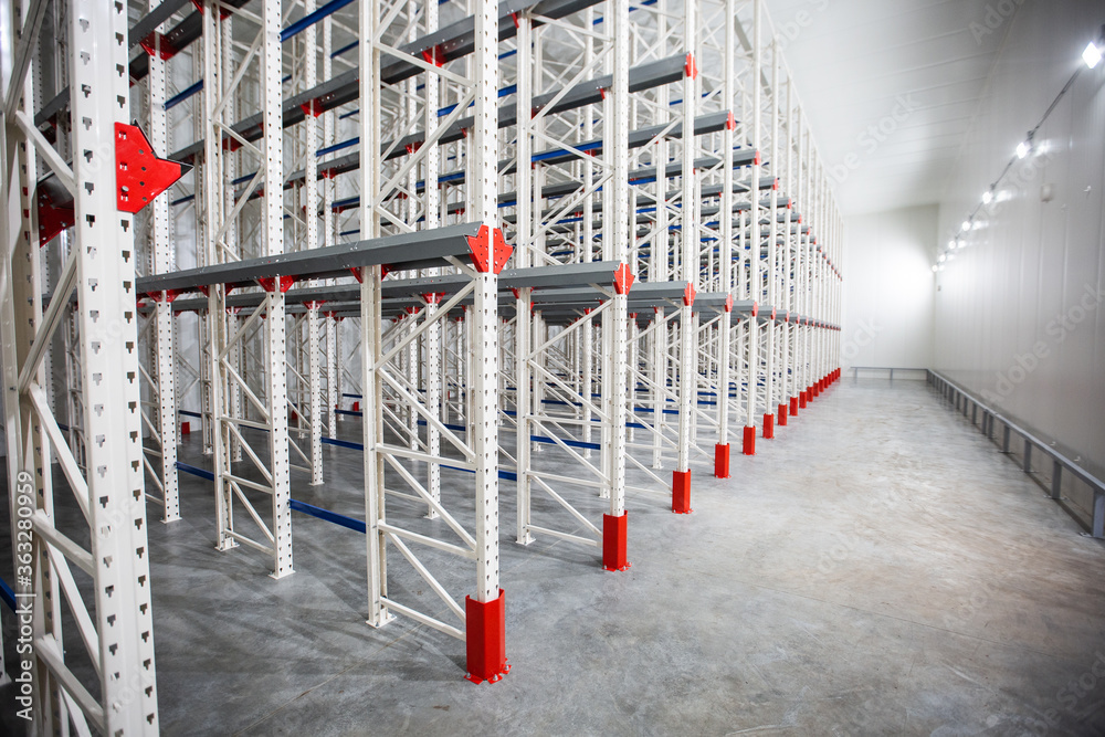 Warehouse Cantilever Racking Systems for storage Aluminum Pipe or profiles. Pallet Rack and Industrial Warehouse Racking. Steel profiles. Interior of Empty Big Huge Warehouse.