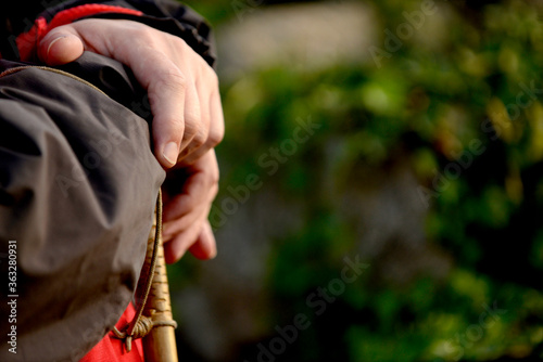 Man's hands with wooden stick