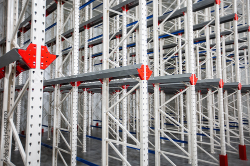 Warehouse Cantilever Racking Systems for storage Aluminum Pipe or profiles. Pallet Rack and Industrial Warehouse Racking. Steel profiles. Interior of Empty Big Huge Warehouse.