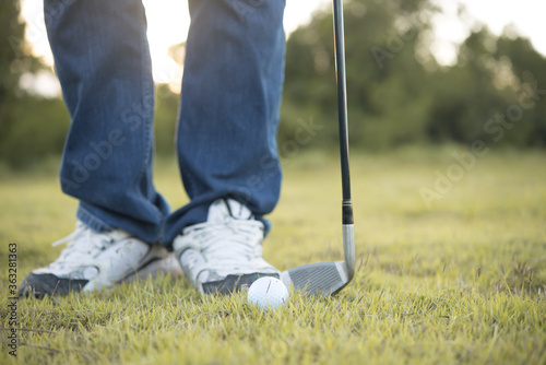 Hand of asian golfer holding golf on lawn,thailand people play golf