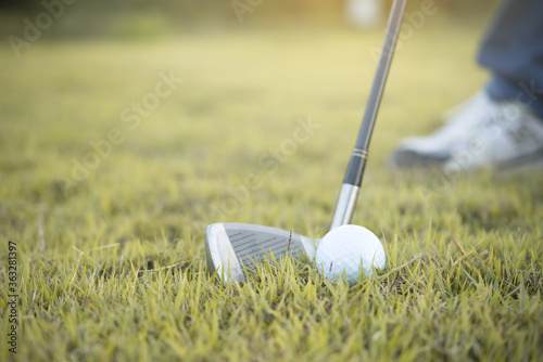 Hand of asian golfer holding golf on lawn,thailand people play golf
