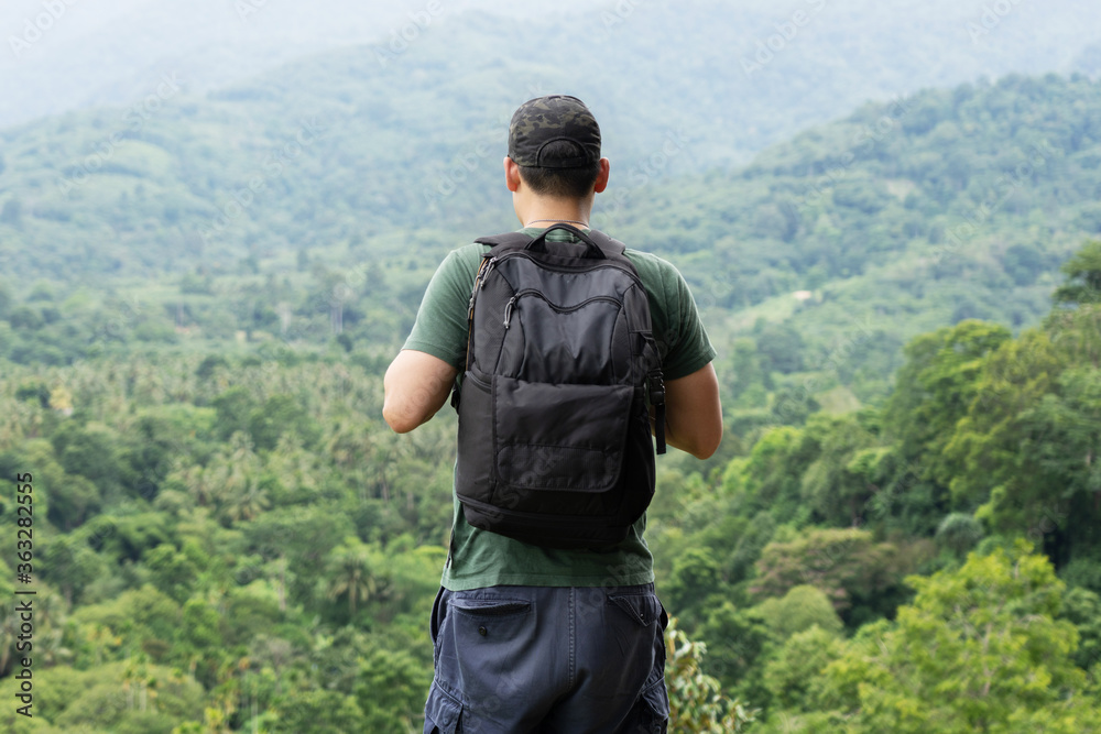 Asian Traveler with Backpack  Look through the Forest