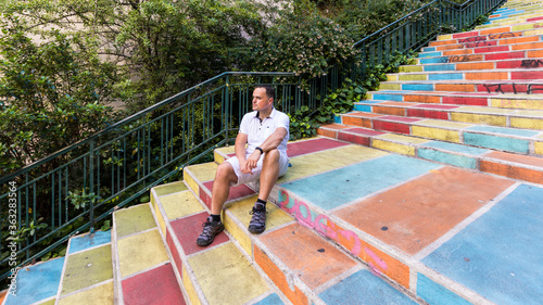 Man sitting on a colored stair in Lyon in france