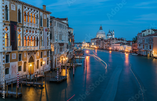 View of Basilica di Santa Maria della Salute and grand canal from Accademia Bridge at night in Venice  Italy.