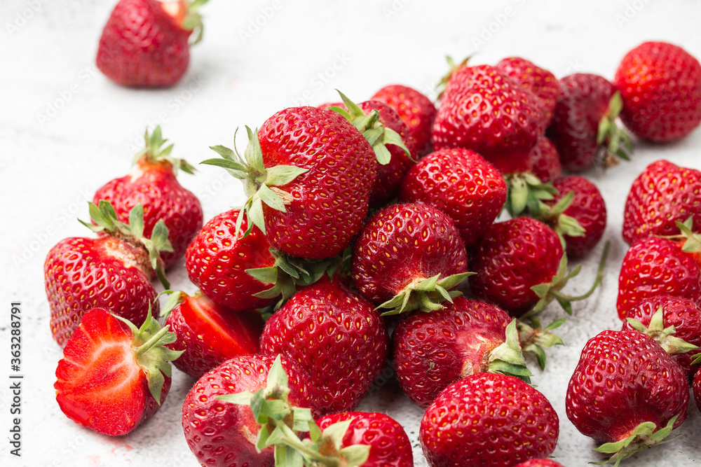 Fresh ripe perfect strawberry on white marble background. Fresh strawberry as texture background. Natural food backdrop with red berries. Strawberries sale in a food market in summer. Fresh ripe perfect strawberry on white marble background. Fresh strawberry as texture background. Natural food backdrop with red berries. Strawberries sale in a food market in summer.