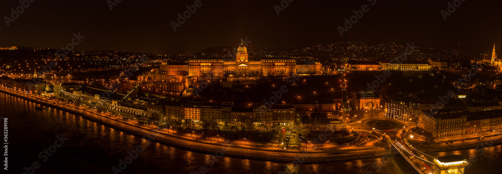 Panoramic aerial drone shot of Buda castle on Buda Hill in Budapest night with city lights on
