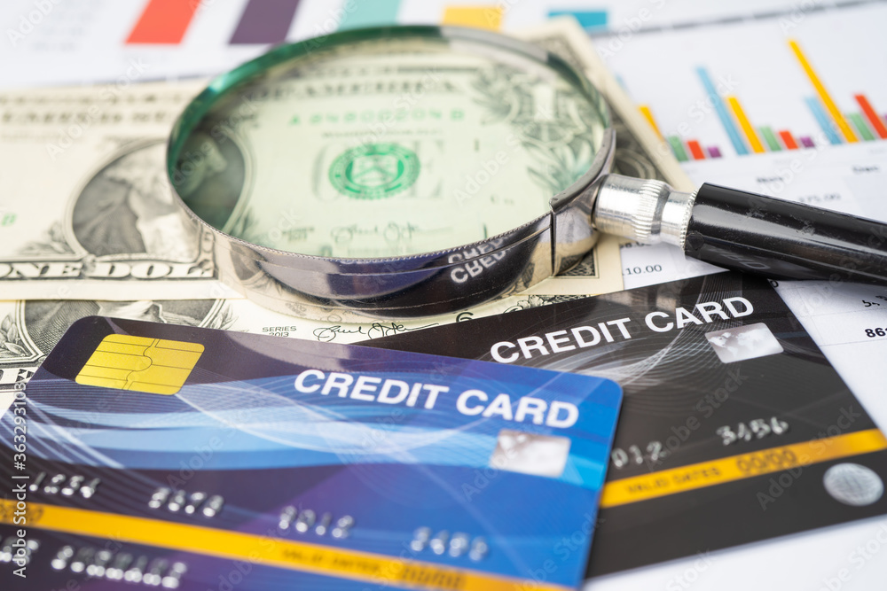 Credit card model with Magnifying glass, Financial development, Accounting, Statistics, Investment Analytic research data economy office Business company banking concept. Credit card model with Magnifying glass, Financial development, Accounting, Statistics, Investment Analytic research data economy office Business company banking concept.