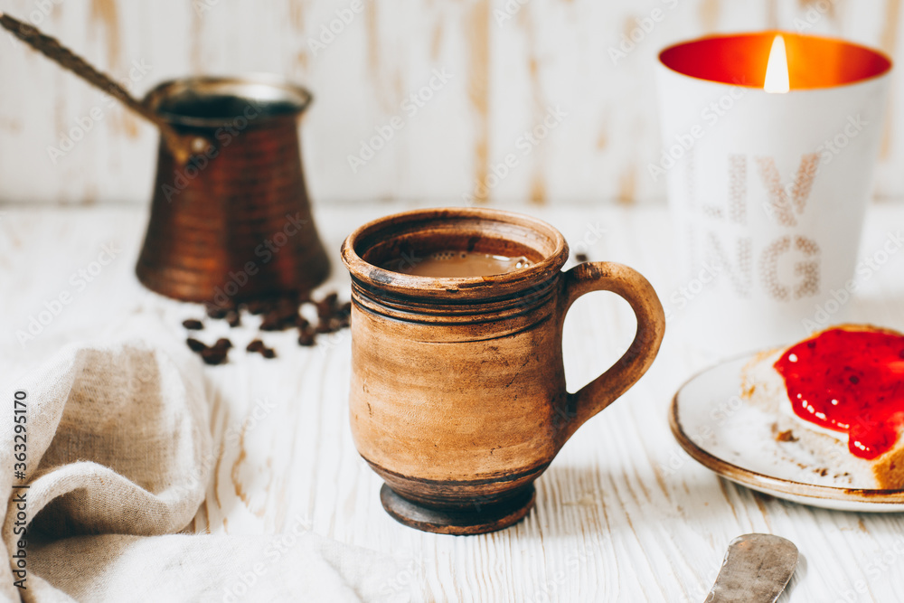 Coffee, toast and jam on a white wooden table Coffee, toast and jam on a white wooden table