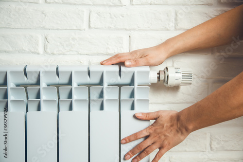 woman hand in hot radiator