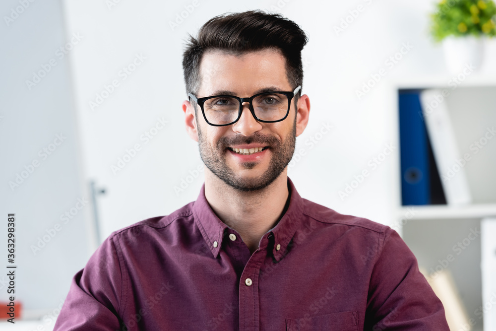 happy, handsome businessman in eyeglasses smiling while looking at camera happy, handsome businessman in eyeglasses smiling while looking at camera