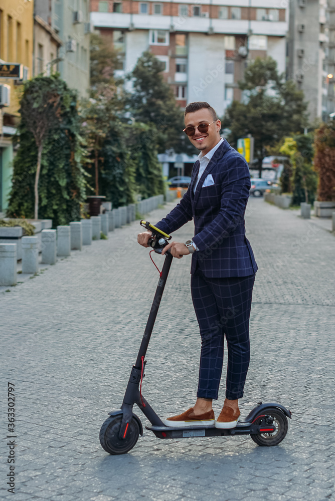 Young bussinesman with electric scooter posing during work break. Young bussinesman with electric scooter posing during work break.