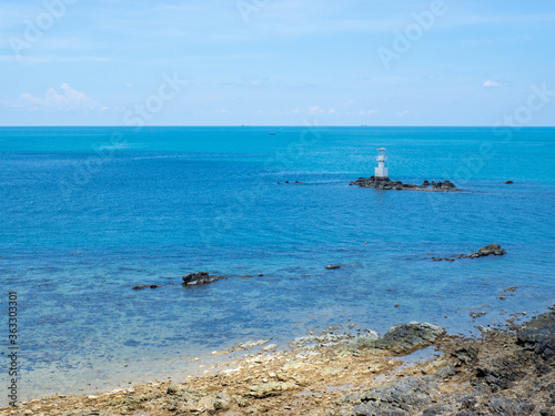 Wallpaper Mural Lighthouse in bright sunny summer day in the sea of Thailand. Rocky coast under the blue sky with cloud and calm water. Torontodigital.ca
