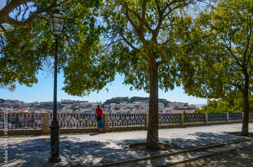 View of old town and Sao Jorge Castle from Sao Pedro de Alcantara viewpoint (miradouro), in Lisbon, Portugal.