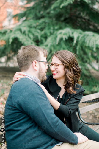 A couple in love having a romantic moment and showing mutual affection in a local urban park outdoors