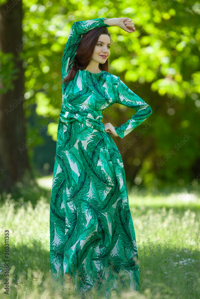 young woman in a long green dress young woman in a long green dress