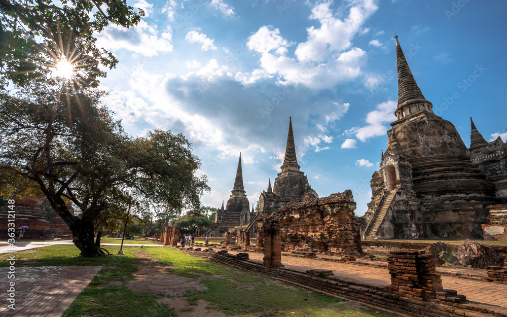 Group of tourists walking to admire the beauty of ancient pagodas in the historical park, Wat Phra Si Sanphet Temple, Ayutthaya, Thailand, Oct 26, 2019.