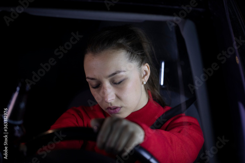 Tired woman sitting inside car fell asleep at wheel of car, exhausted female driver dozed off after long hard trip, car night ride, night trip, people, driving caution, problems with transport