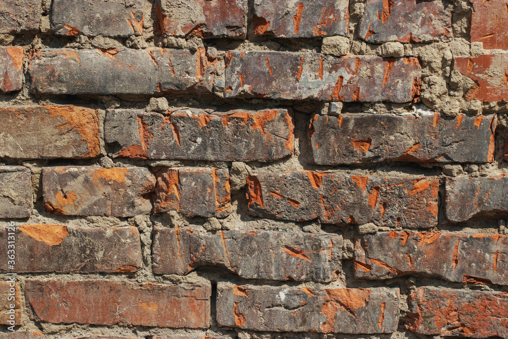 Part of the brick wall of the house during the repair. Texture: bricks and concrete. Part of the brick wall of the house during the repair. Texture: bricks and concrete.