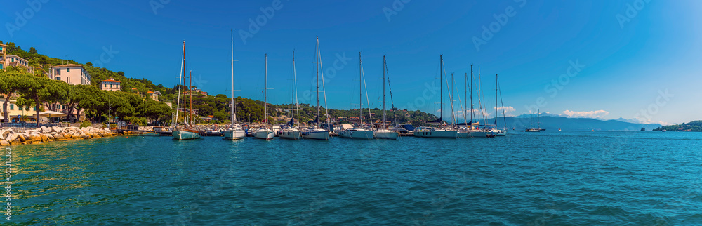Sailing boats moored along a wharf in Porto Venere, Italy in the summertime