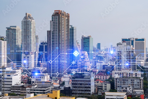 Technology hologram over panorama city view of Bangkok. The largest tech hub in Asia. The concept of developing coding and high-tech science. Double exposure.
