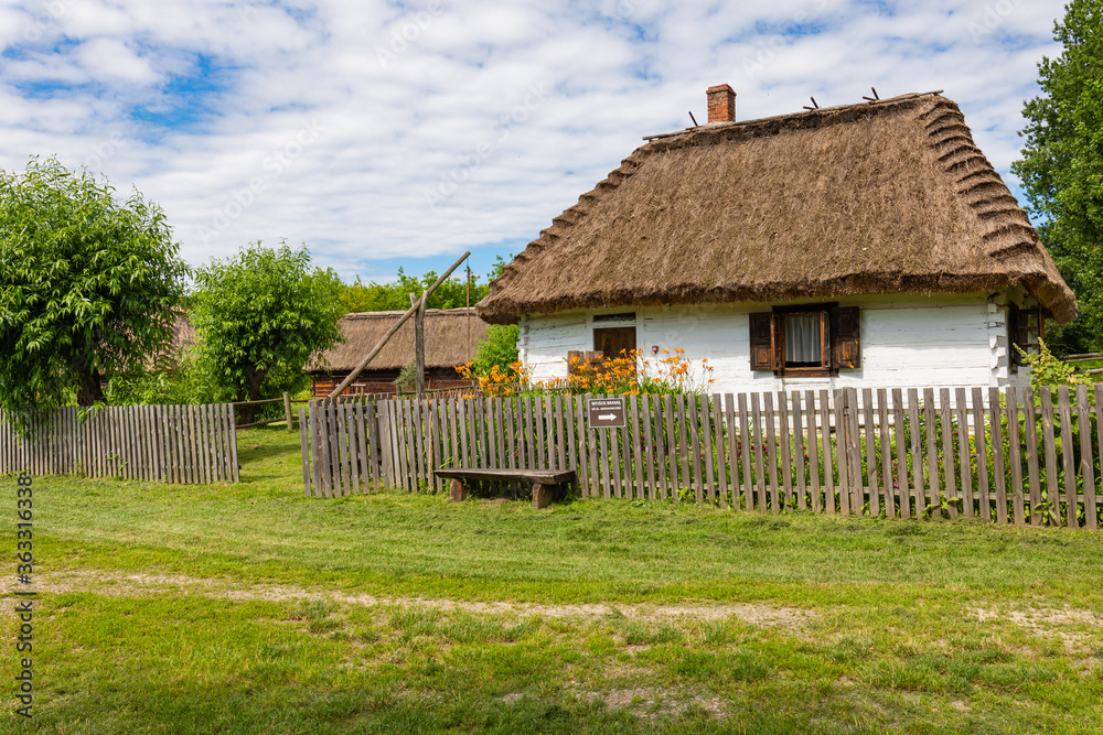 Traditional village in Poland. Open Air Museum. Wooden houses. Wooden folk architecture from different areas of the Lublin Voivodeship. Poland - obrazy, fototapety, plakaty 