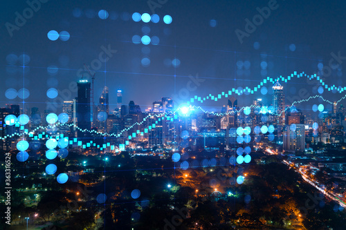 FOREX graph hologram, aerial night panoramic cityscape of Bangkok, the developed location for stock market researchers in Asia. The concept of fundamental analysis. Double exposure.