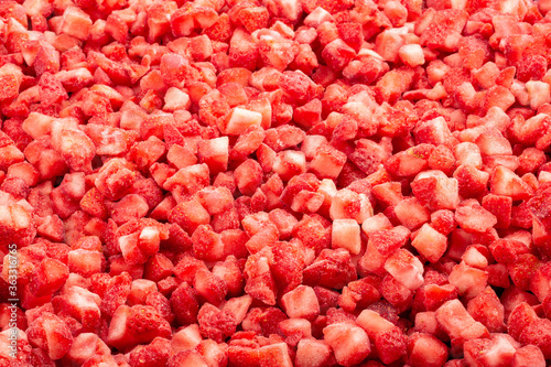 Tablou pe pânză Frozen diced strawberry. Food background. Top view
