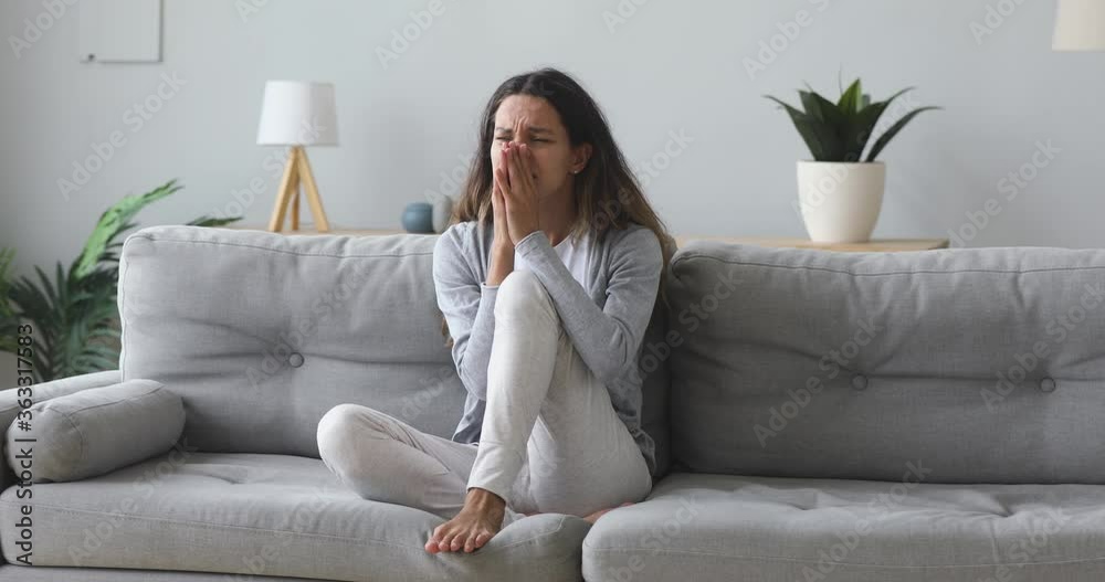 Stressed worried young woman feeling desperate about problem hurt upset sit alone on sofa at home, sad anxious girl troubled with abortion, frustrated by unwanted pregnancy, regret of bad mistake Stressed worried young woman feeling desperate about problem hurt upset sit alone on sofa at home, sad anxious girl troubled with abortion, frustrated by unwanted pregnancy, regret of bad mistake