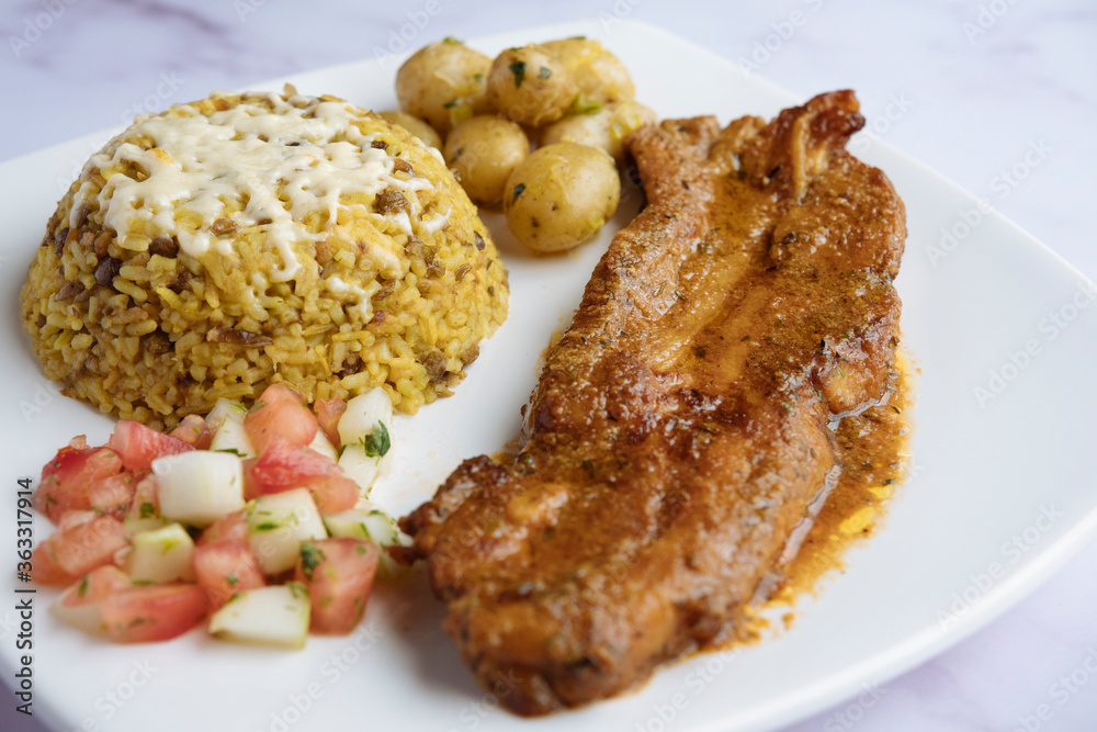 Rice with lentils, baked pork ribs, boiled potatoes, and tomato cucumber salad. Arroz moro. Rice with lentils, baked pork ribs, boiled potatoes, and tomato cucumber salad. Arroz moro.