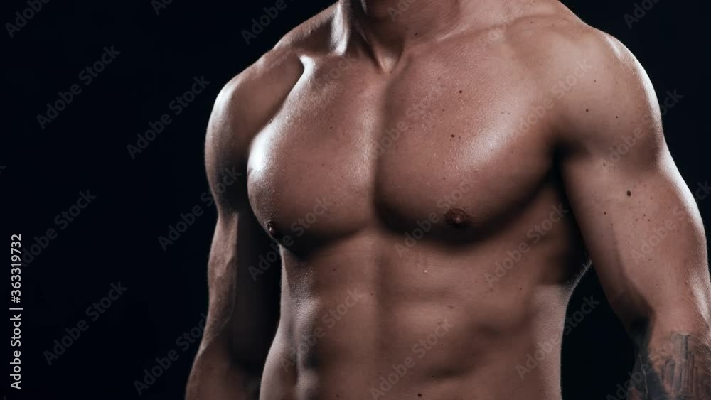 Fit and sporty bodybuilder over black background. Bodybuilder training using dumbbells. Sport and fitness. Fit and sporty bodybuilder over black background. Bodybuilder training using dumbbells. Sport and fitness.