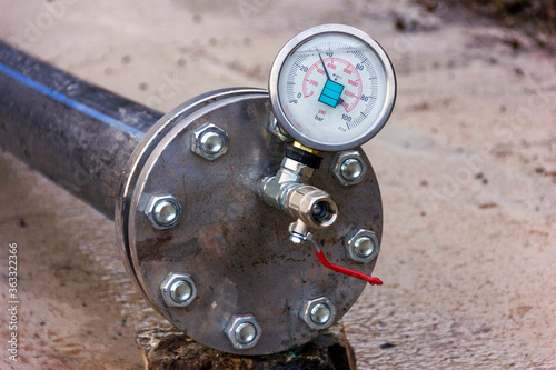 Hydrostatic testing for polyethylene pipeline and view of the manometer ( According to EN 837-1 Standard ) with the calibrated at pressure. Psi ( Bar ) is a pressure unit. photo