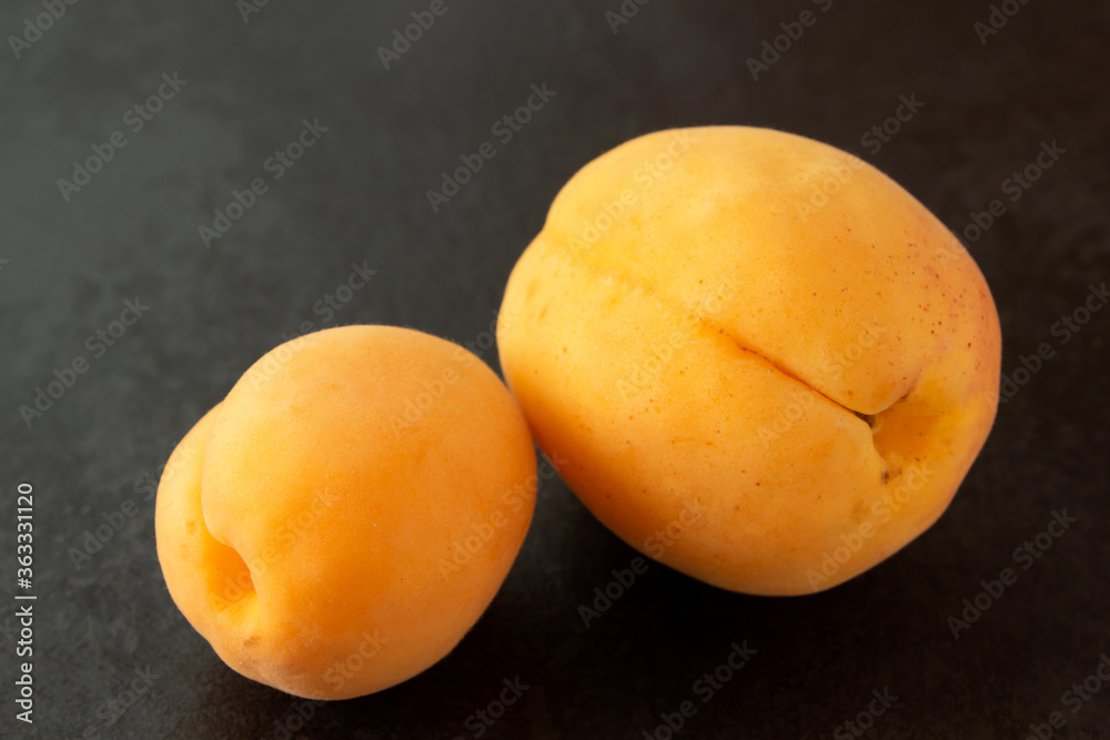 Fresh apricot on a dark painted background close up