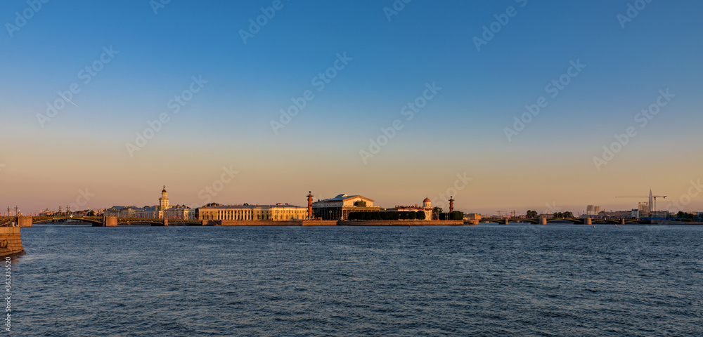 Sunrise panorama of Neva river, bridges and the Spit of Vasilyevsky island after summer white night. Saint-Petersburg, Russia.