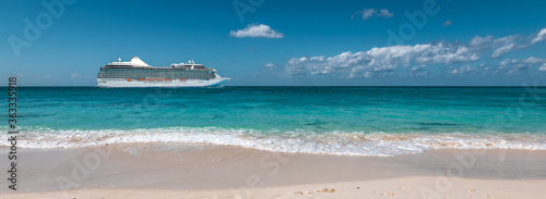 
Side view of luxurious cruise ship at the beautiful white sand beach of the Cayman Islands in the Caribbean.