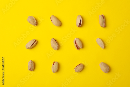 Flat lay with pistachio on yellow background. Vitamin food