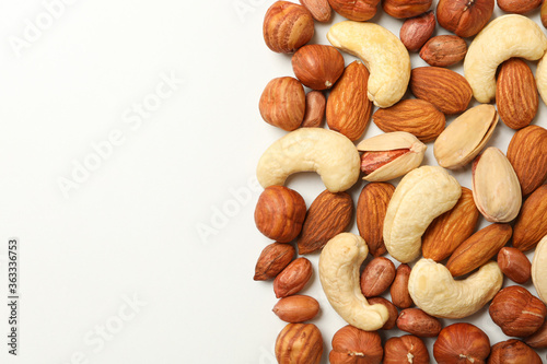 Different tasty nuts on white background. Vitamin food