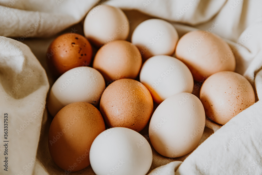 Organic, free range eggs on linen cloth. Cake, pasta or dough recipe ingredients. Top view on table. Concept of ecological egg farm and egg consumption Organic, free range eggs on linen cloth. Cake, pasta or dough recipe ingredients. Top view on table. Concept of ecological egg farm and egg consumption