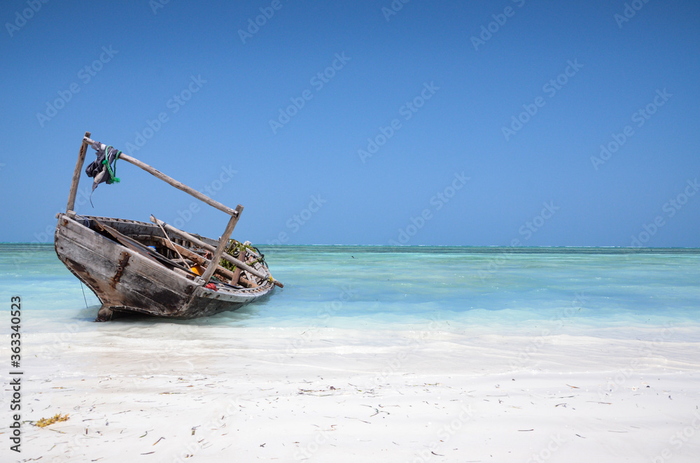 Boat standing on the beach with the sea in the background
