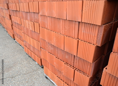 Wall blocks made from red porous ceramics with rectangular holes on a pallet 