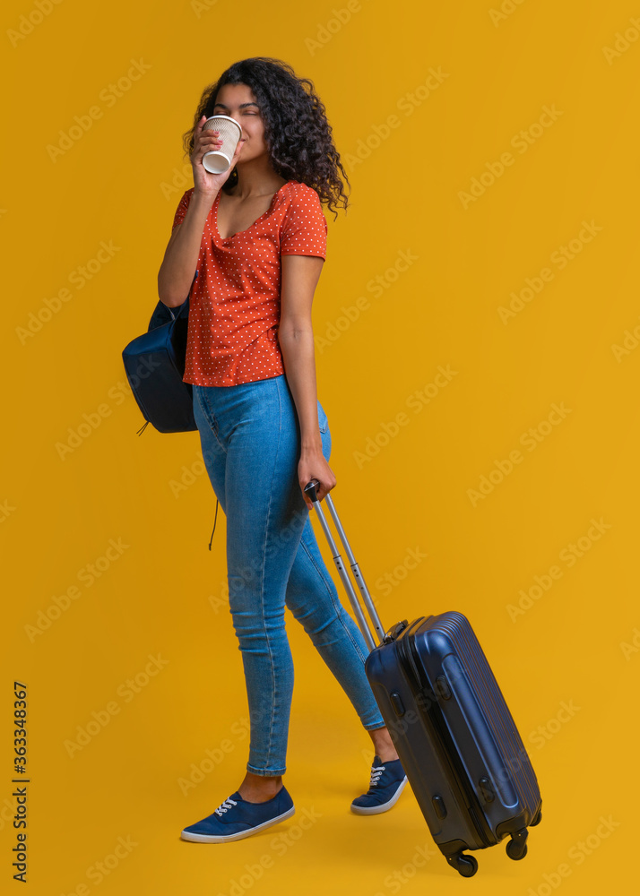 Full length portrait of cute dark skinned traveler girl walking with ...