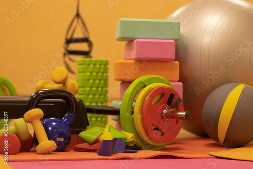 Set composition of various bright sports equipment. Kettlebells, fitness bands, balls, rugs, dumbbells, barbell, step platform. Sport concept. High quality photo