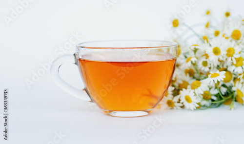 cup of herbal chamomile tea and daisy flowers on white background doctor treatment and prevention of immune concept, medicine - folk, alternative, complementary, traditional medicine