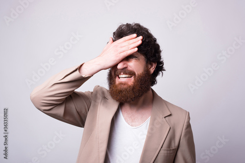 Tablou canvas Oh no gesture, facepalm made by a bearded hipster man over white background