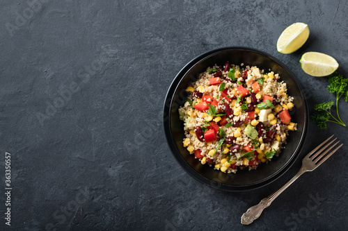 mexican quinoa bowl on a dark background, top view, place for text
