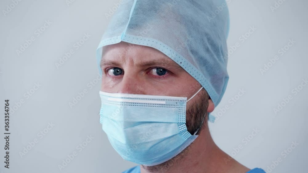 close-up of the face and the piercing gaze of the crying doctor who could not save a life of fatigue and despair in the eyes of close-up of the face and the piercing gaze of the crying doctor who could not save a life of fatigue and despair in the eyes of