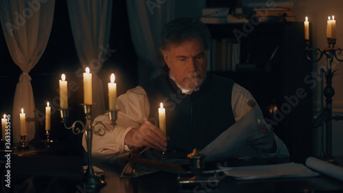 Obraz na plátně 18th century businessman looking at a map in is office