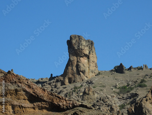 A rock against a bright blue sky.